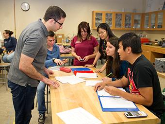 Informatics and Engineering Systems Academics -  a professor helps students with an assignment